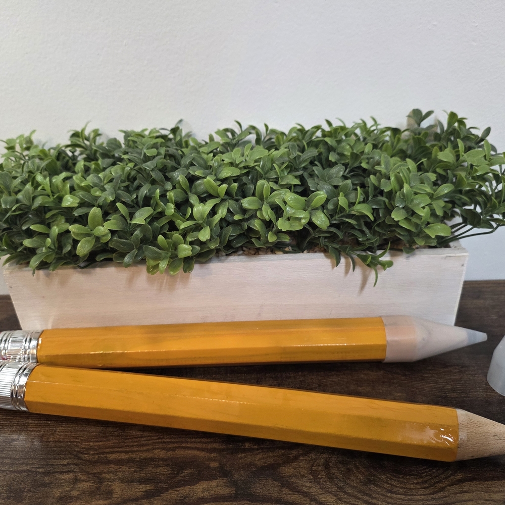 Vibrant Orange Pencil Planter with Green Foliage